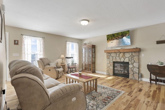 living room with a fireplace and light hardwood / wood-style floors