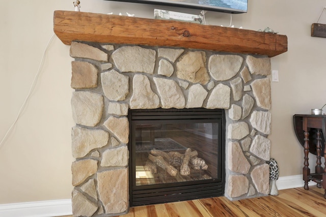 details featuring wood-type flooring and a stone fireplace