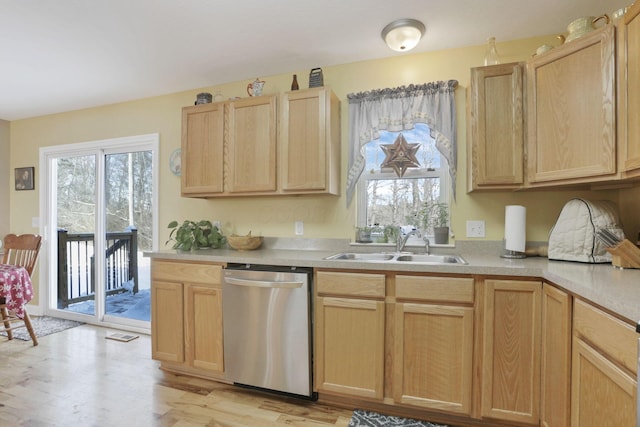 kitchen featuring sink, light hardwood / wood-style floors, dishwasher, and light brown cabinets