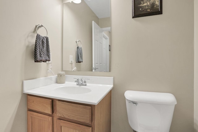 bathroom with toilet and vanity