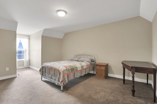 carpeted bedroom with lofted ceiling