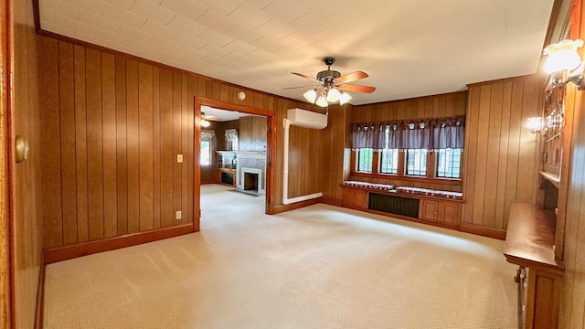 unfurnished living room with radiator heating unit, light colored carpet, a wall mounted AC, and wooden walls