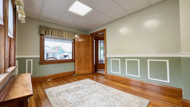 spare room featuring a paneled ceiling and hardwood / wood-style flooring