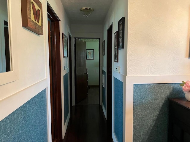 hallway featuring a textured ceiling