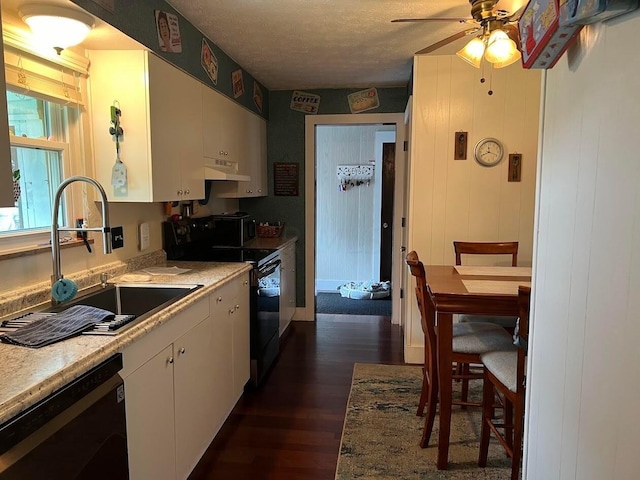 kitchen featuring ceiling fan, sink, black appliances, white cabinets, and dark hardwood / wood-style floors