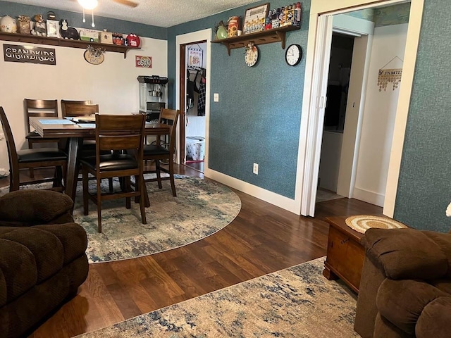 dining space with a textured ceiling, ceiling fan, and dark hardwood / wood-style floors