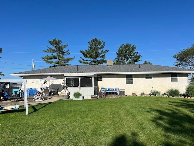 back of property featuring a patio area and a lawn