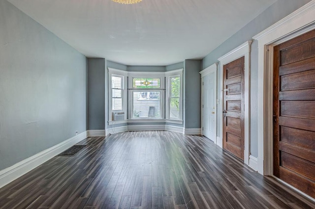 empty room featuring dark hardwood / wood-style flooring and cooling unit