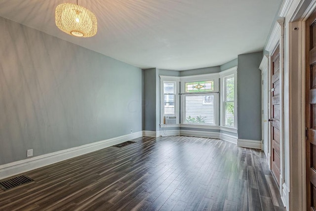 empty room with cooling unit and dark wood-type flooring