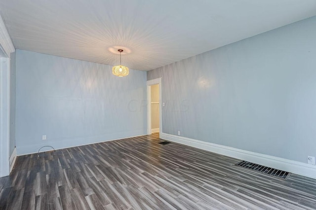 spare room with dark hardwood / wood-style floors