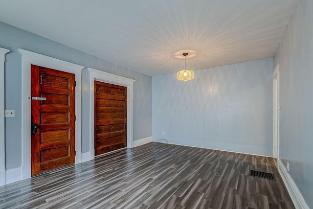 spare room featuring dark hardwood / wood-style floors