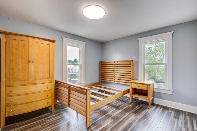 bedroom with dark hardwood / wood-style floors