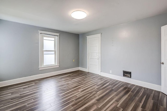 spare room featuring dark hardwood / wood-style flooring