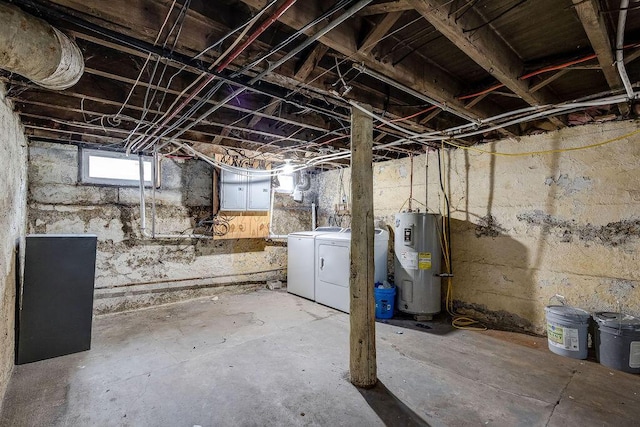 basement with electric water heater and washing machine and clothes dryer