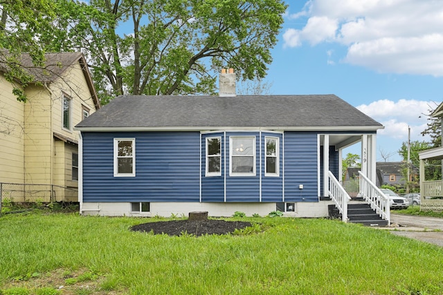 view of front of property with covered porch and a front yard