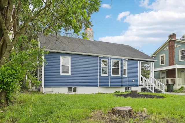 rear view of house with a lawn