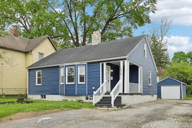 bungalow-style house featuring an outbuilding and a garage