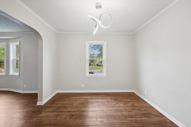 empty room with crown molding and dark wood-type flooring