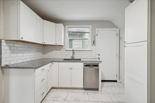 kitchen with white cabinets, tasteful backsplash, sink, dark stone countertops, and dishwasher