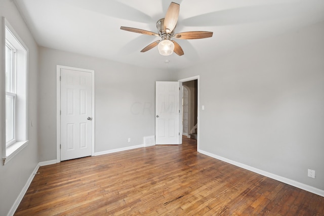 empty room featuring hardwood / wood-style floors and ceiling fan