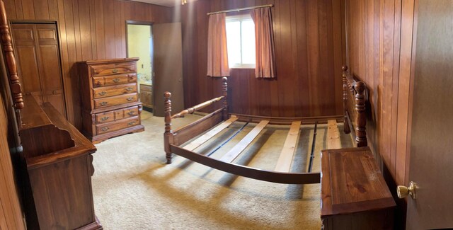 bedroom with carpet and wooden walls