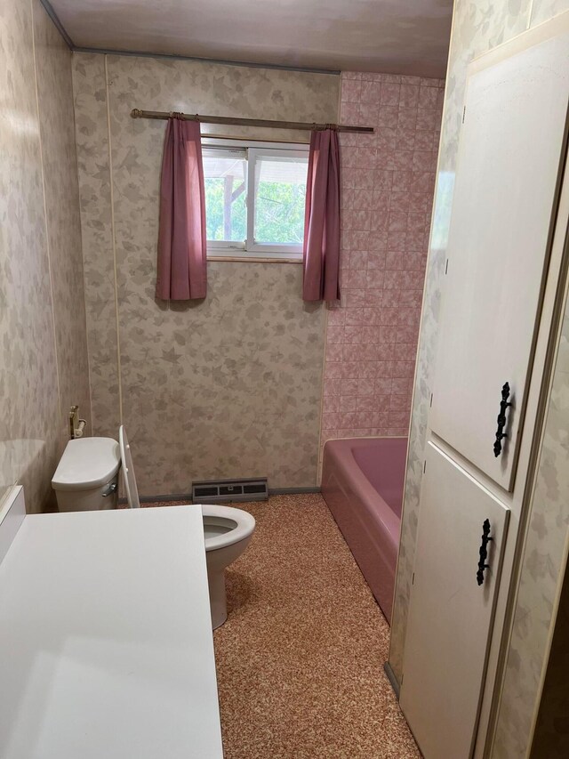 bathroom with a bath and toilet