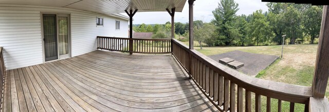 wooden deck featuring a yard