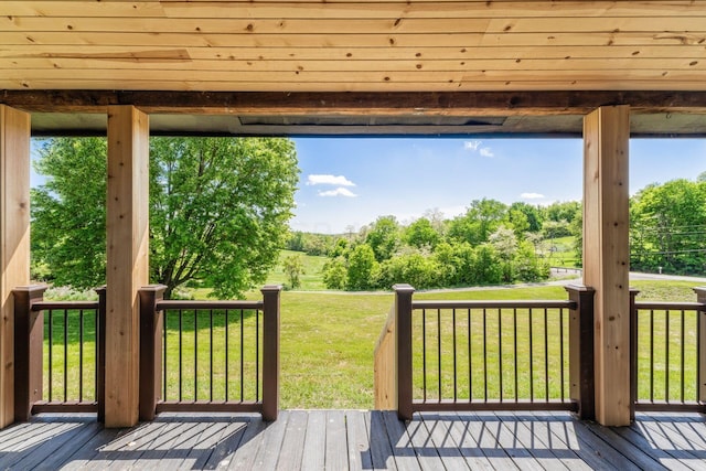 wooden terrace featuring a yard