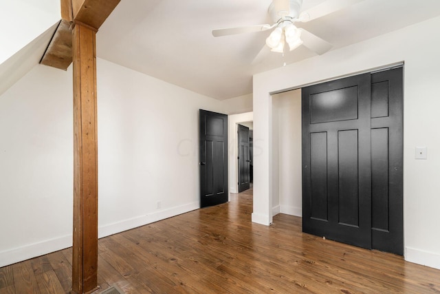 unfurnished bedroom featuring a closet, ceiling fan, and dark hardwood / wood-style flooring