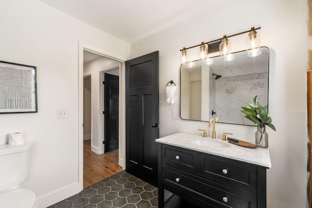 bathroom with hardwood / wood-style floors, vanity, and toilet