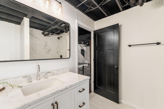 bathroom with vanity and a tile shower