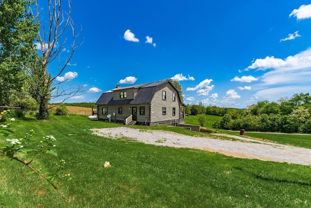 rear view of house featuring a yard