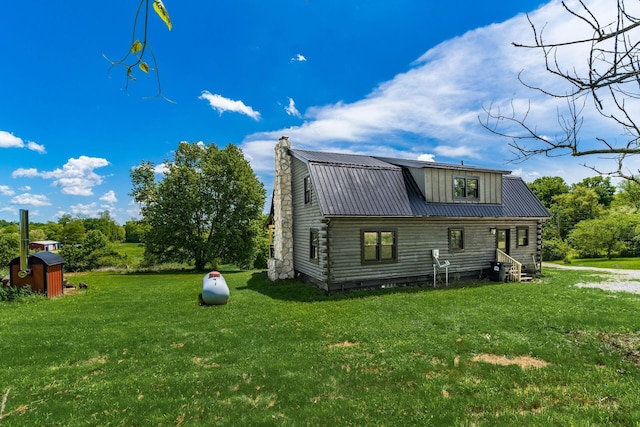 back of house with a yard