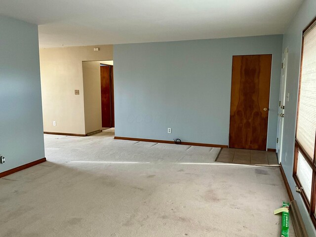 carpeted empty room with a wealth of natural light