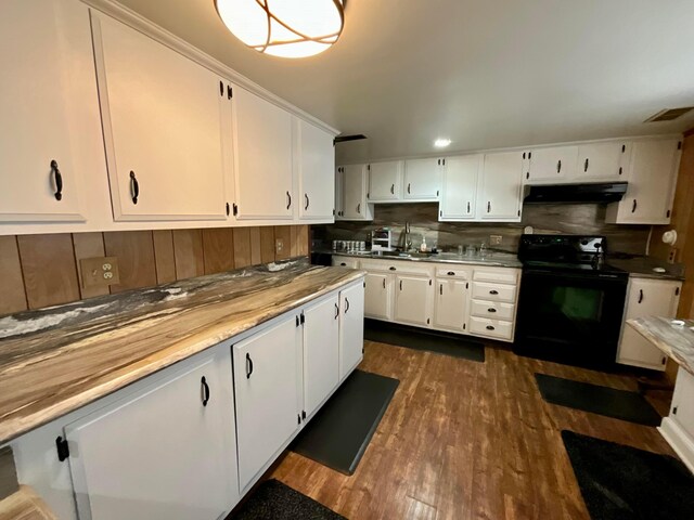 kitchen with backsplash, black range with electric stovetop, sink, dark hardwood / wood-style flooring, and white cabinetry