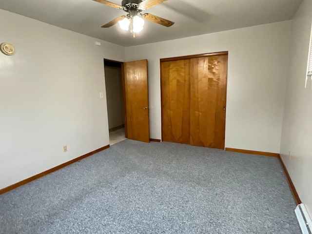 unfurnished bedroom with carpet, a closet, baseboard heating, and ceiling fan