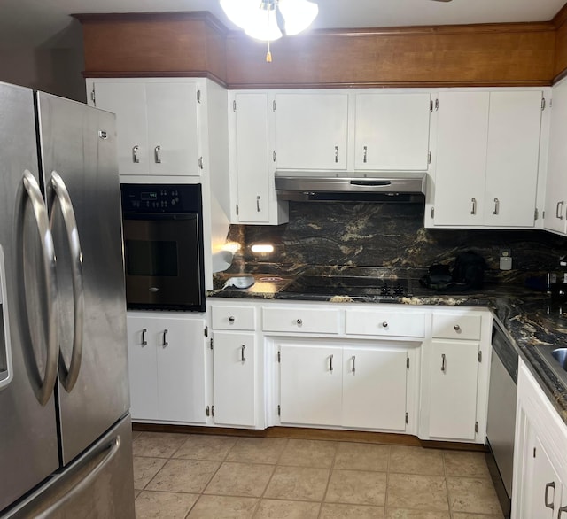 kitchen with white cabinetry, dark stone countertops, decorative backsplash, light tile patterned flooring, and appliances with stainless steel finishes