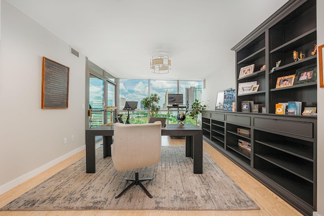 office space with hardwood / wood-style flooring and expansive windows