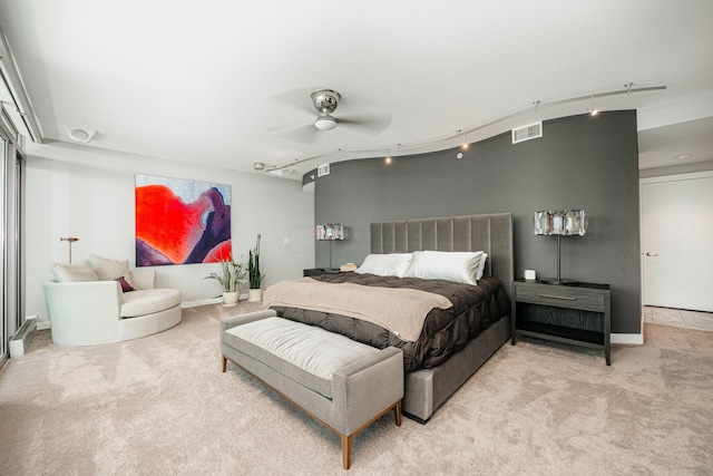 carpeted bedroom featuring ceiling fan and track lighting