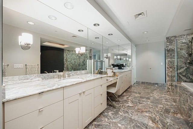 bathroom with a tile shower and vanity