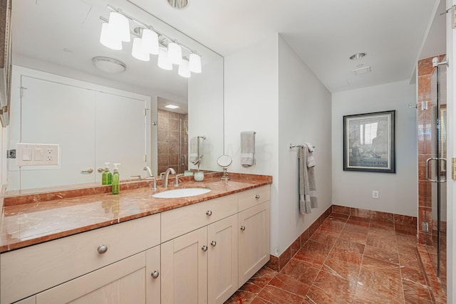 bathroom with vanity and a shower with door