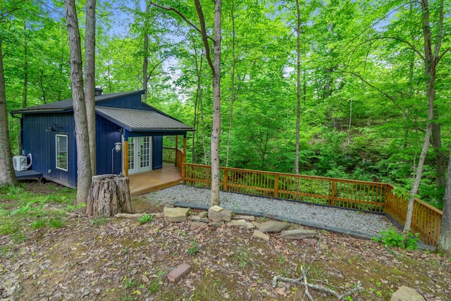 view of property exterior featuring french doors and a deck