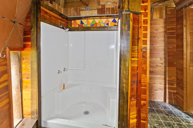 bathroom featuring wooden walls