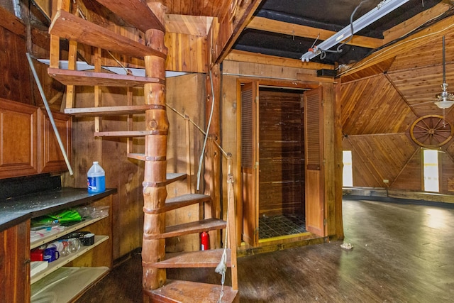 basement featuring wood walls