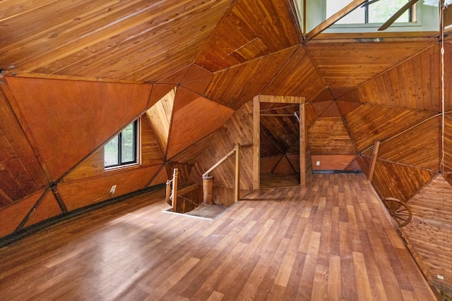 additional living space featuring hardwood / wood-style floors and a skylight