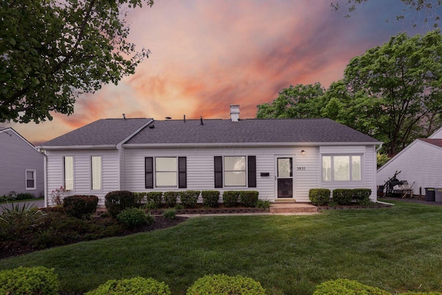 single story home with a lawn