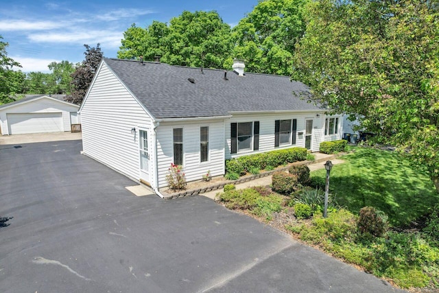 view of front of property featuring a garage and an outbuilding