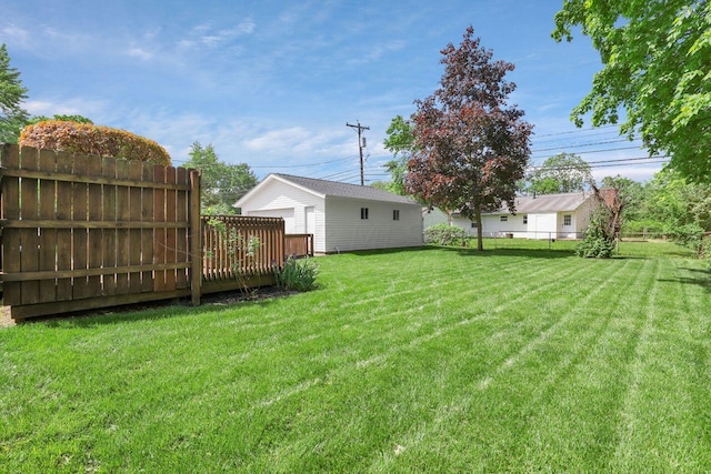 view of yard with a wooden deck and an outbuilding