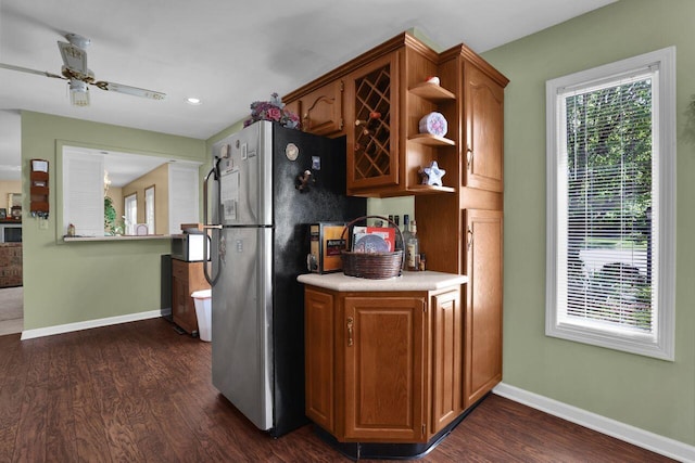 kitchen featuring dark hardwood / wood-style floors, ceiling fan, and stainless steel appliances