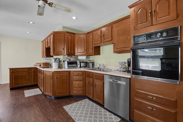 kitchen featuring dishwasher, sink, dark hardwood / wood-style floors, ceiling fan, and black oven